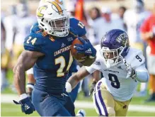  ?? STAFF PHOTO BY ROBIN RUDD ?? UTC’s Elijah Ibitokun-Hanks outruns Western Carolina’s John Brannon III for a touchdown during the Mocs’ 60-36 win Sept. 28 at Finley Stadium. Ibitokun-Hanks was injured during the victory and missed the next four games but returned last Saturday at Samford, where he rushed for 139 yards and scored three touchdowns.