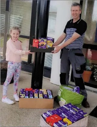  ??  ?? Carly Ryan (10), presents the Easter eggs to caretaker Billy Morrissey.