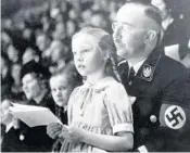  ?? ASSOCIATED PRESS FILE ?? Heinrich Himmler, chief of the German Police and Minister of the Interior, holds daughter Gudrun on his lap in 1938.
