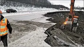  ?? CHRIS RIEKENA/AP ?? Excavation work begins Saturday near the Mirror Lake exit of the Glenn Highway near Eklutna, Alaska, to prepare the road for repaving. The highway was damaged by quakes.