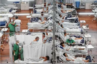  ?? Andre Penner / Associated Press ?? COVID patients are treated at a field hospital built inside a sports coliseum on March 4 in Santo Andre on the outskirts of Sao Paulo, Brazil. Hopes are rising that the pandemic is ebbing in the U.S. and Europe.