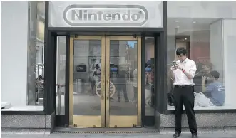  ?? VICTOR J. BLUE/BLOOMBERG ?? A gamer plays Pokemon Go outside the Nintendo store at Rockefelle­r Center in New York on Wednesday. Nintendo has the potential to capture a larger share of the $57B mobile gaming market: