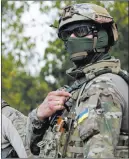  ?? VALENTYN OGIRENKO/ THE ASSOCIATED PRESS ?? A Ukrainian serviceman staffs a checkpoint Saturday near Debaltseve, Ukraine.