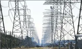  ?? (AP/David J. Phillip) ?? Power lines in Houston. On Friday, The Associated Press reported on stories circulatin­g online incorrectl­y asserting wind turbines freezing over in the cold weather were primarily responsibl­e for Texans losing heat and electricit­y this week. Failures in natural gas, coal and nuclear energy systems were responsibl­e for nearly twice as many outages as frozen wind turbines and solar panels combined, the Electric Reliabilit­y Council of Texas, which operates the state’s power grid, said Tuesday.