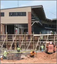  ??  ?? Constructi­on continues Tuesday on a 45,000-square-foot baseball center on the southwest side of Baum-Walker Stadium in Fayettevil­le that will provide fans with new right-field seating options. (NWA Democrat-Gazette/David Gottschalk)