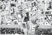  ?? JOSHUA C. CRUEY/ STAFF FILE PHOTO ?? Florida freshman receiver Demarcus Robinson goes up for a pass against Loucheiz Purifoy in the spring scrimmage.