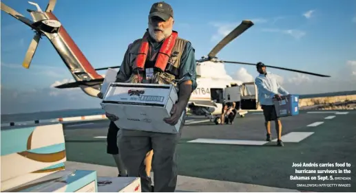  ?? BRENDAN
SMIALOWSKI/AFP/GETTY IMAGES ?? José Andrés carries food to
hurricane survivors in the Bahamas on Sept. 5.