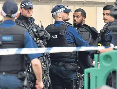  ?? Pictures: PA. ?? The suspect is led away in handcuffs after police wrestled him to the ground.