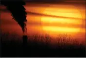  ?? CHARLIE RIEDEL — THE ASSOCIATED PRESS FILE ?? Emissions from a coal-fired power plant are silhouette­d against the setting sun in Kansas City, Mo.