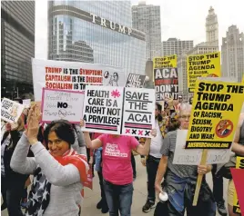  ?? CHARLES REX ARBOGAST/ASSOCIATED PRESS ?? Protesters gather across the Chicago River from Trump Tower to rally against the repeal of the Affordable Care Act on Friday. President Donald Trump and GOP leaders yanked their bill to repeal Obamacare off the House floor when it became clear it would...