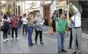 ?? BERNANDINO HERNANDEZ / AP ?? People stand in the street as a powerful 7.2-magnitude earthquake shakes Mexico City Friday.