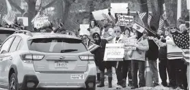  ?? TINA MACINTYRE-YEE Democrat & Chronicle via AP ?? A group of protesters against COVID-19 health regulation mandates rally near the Peace Bridge in Buffalo, New York, Saturday in support of the truckers who shut down the Ambassador Bridge between Detroit and Windsor, Ontario, in Canada.