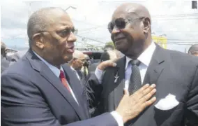  ??  ?? Leader of the Opposition Dr Peter Phillips (left) consoles Dr Conrad Douglas, brother of Easton Douglas, following the funeral service for his brother yesterday.