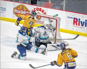  ?? OLIVIER CHIASSON ?? Noah McMullin scores his first goal of the night in Game 1 of the MHL final for the Mariners as the puck enters the net behind Edmundston Blizzards goalie Francis Asselin on the glove side. McMullin went on to score a hat-trick in this game.