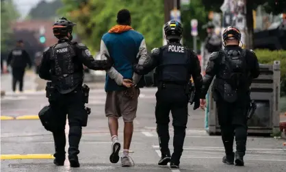  ?? Photograph: David Ryder/Getty Images ?? Police detain a person as city crews dismantle Chop in Seattle, Washington, on Wednesday.