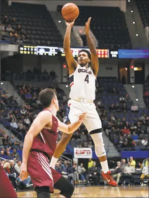  ?? Jessica Hill / Associated Press ?? UConn’s Jalen Adams shoots over Lafayette’s Kyle Stout during Wednesday night’s game at the XL Center in Hartford.