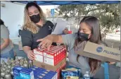  ?? Dan Watson/The Signal ?? Samual Dixon Family Health Center employees Iris Diaz, left, and Norma Juarez prepare for the annual turkey dinner food drive for families in need on Tuesday.