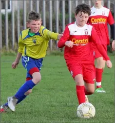  ??  ?? Ben Walsh of Moyne Rangers is chased by P.J. Mackey of New Ross Town.
