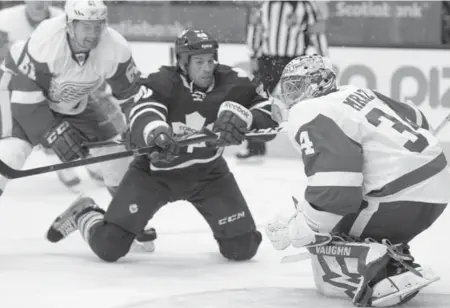  ?? FRANK GUNN/THE CANADIAN PRESS ?? Forward Troy Bodie, centre, snagged a roster spot with the Leafs when the team placed Frazer McLaren on long-term injury reserve Monday.