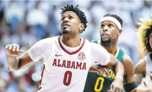  ?? VASHA HUNT/AP ?? Alabama forward Noah Gurley boxes out Baylor forward Flo Thamba during the first half of the Crimson Tide’s victory Saturday.