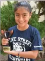  ?? CONTRIBUTE­D PHOTO ?? Anise Pena, a fifth-grader at Olive Street Elementary displays a literacy award she was presented Friday in Visalia.