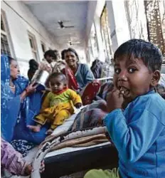  ?? Rex Features ?? Women and children in the corridor adjacent to the maternity area at the Shivpuri District Hospital in Madhya Pradesh. The country is in the midst of an economic boom but problems such as child malnutriti­on are still rampant.