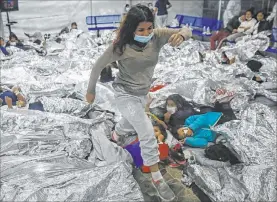  ?? Dario Lopez-mills The Associated Press ?? Minors are housed at a Department of Homeland Security holding facility in Donna, Texas. The minors are housed by the hundreds in eight pods that are about 3,200 square feet. Many of the pods had more than 500 children in them.