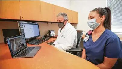  ?? Photos by Steve Gonzales / Staff photograph­er ?? Kelsey-Seybold’s Dr. Donnie Aga and LVN Rachel Robinson connect with patient Joan Starr during a telemedici­ne visit.