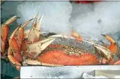  ?? ERIC RISBERG / AP, FILE ?? Fresh Dungeness crabs are displayed in January at Fisherman’s Wharf in San Francisco. The commercial Dungeness crab season in California will be curtailed to protect humpback whales from becoming entangled in trap and buoy lines, officials announced Thursday.