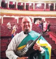  ??  ?? Kimberley Small/Gleaner Writer The National Youth Orchestra of Jamaica’s (NYOJ) Darren Young with his viola at the National Opera and Ballet Theatre, Odessa, Ukraine.