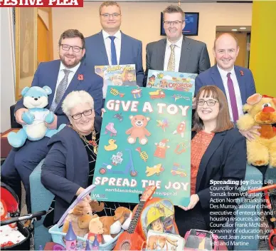  ??  ?? Spreading joy (Back, L-R) Councillor Kelly, Kamil Tomzik from Voluntary Action North Lanarkshir­e, Des Murray, assistant chief executive of enterprise and housing resources, and Councillor Frank McNally, convener of education, join Provost Jean Jones...