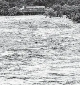  ?? William Luther / Staff photograph­er ?? A large truck crossed over a flooded Leon Creek on Culebra Road on the city’s West Side after heavy rains raised the creek levels Tuesday.