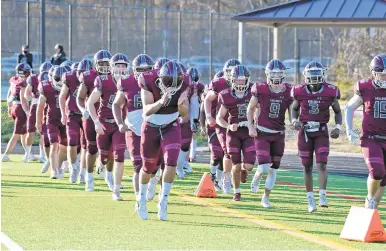  ?? PAUL W. GILLESPIE PHOTOS/CAPITAL GAZETTE ?? Broadneck football, seen coming out onto the field during the spring season, is projected to be one of Anne Arundel’s best teams this fall.