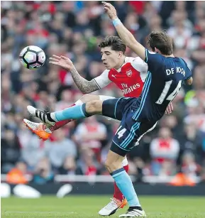  ?? — GETTY IMAGES ?? Arsenal’s Hector Bellerin, left, vies with Middlesbro­ugh’s Marten de Roon for the ball during their English Premier League game Saturday at Emirates Stadium in London.