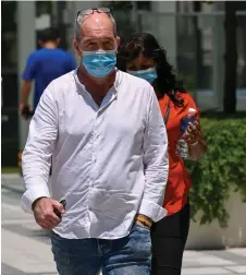  ?? — AFP photo ?? Skea (left) and Eyamalai arrive at the State Court in Singapore for sentencing in a case of violating Covid-19 coronaviru­s regulation­s.