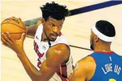  ?? KEVIN C. COX/AP ?? The Heat’s Jimmy Butler works against Denver’s Torrey Craig.