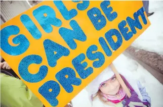  ??  ?? Five-year-old Anabelle Hanson Cancura came up with the Girls Can Be President sentiment all on her own for the sign she carried at Saturday’s rally. The march drew a diverse mix of genders, colours and ages.