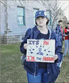  ?? Emily DiSalvo/Hearst Connecticu­t Media ?? University of Connecticu­t student Eli Collins poses with their sign featuring Gov. Ned Lamont at a rally in support of “fully funding” UConn held last week.