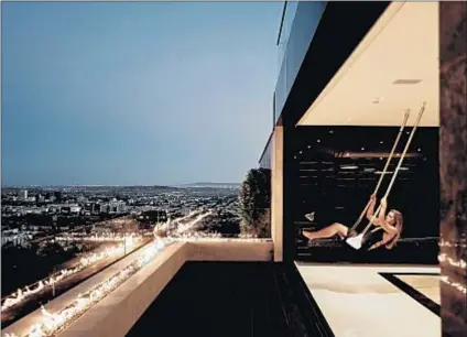  ?? Photograph­s by Alex Zarour Virtually Here Studios ?? IN THE BIRD STREETS area of Hollywood Hills West, a newly built home — with swings in the lounge area and a garage that doubles as a dance club — brought $5.5 million less than listed for.