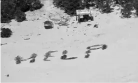  ?? Photograph: US Coast Guard Forces Micronesia ?? Stranded fishermen on the Pikelot atoll spelled out ‘help’ with palm fronds.