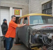  ?? RICHARD ILGENFRITZ — MAIN LINE MEDIA NEWS ?? Chris Raab (left) and David Martino look Woodie” at Martino’s shop in Yeadon. over the “Monster