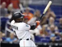  ?? BRYNN ANDERSON — THE ASSOCIATED PRESS ?? The Miami Marlins’ Cameron Maybin hits a solo home run during the fifth inning of a baseball game against the Philadelph­ia Phillies, Sunday in Miami.