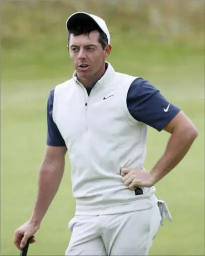  ?? PETER MORRISON — THE ASSOCIATED PRESS ?? Rory McIlroy waits to putt on the 15th green during a practice round ahead of the British Open Golf Championsh­ip in Carnoustie, Scotland on Wednesday.