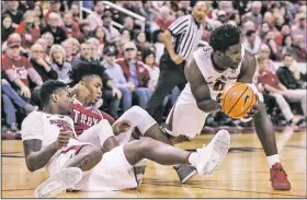  ?? Arkansas Democrat-Gazette/MITCHELL PE MASILUN ?? Arkansas guard Jaylen Barford (right) picks up a loose ball after a scramble Saturday during the Razorbacks’ 88-63 victory over Troy at Verizon Arena in North Little Rock.