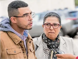  ?? Josie Norris/Staff photograph­er ?? Fatiha Haouass, the mother of Adil Dghoughi, tries to hold back her emotions as she listens to her son Othmane speak to the media Thursday outside court.