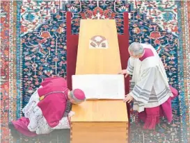  ?? VATICAN MEDIA ?? Archbishop Georg Gaenswein kisses the coffin of Pope Emeritus Benedict XVI during his funeral Thursday in St. Peter’s Square at the Vatican. Benedict, 95, died Saturday.