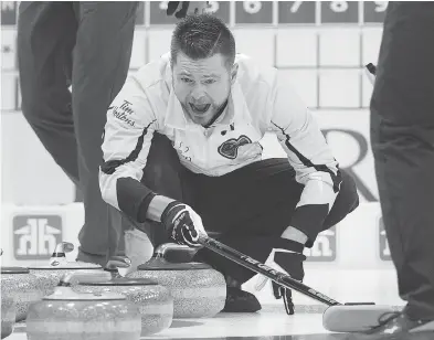  ?? ANDREW VAUGHAN / THE CANADIAN PRESS ?? Manitoba skip Mike McEwen barks out instructio­ns to the sweepers during action at the Tim Hortons Brier in St. John’s. McEwen defeated Brad Jacobs of Northern Ontario 7-5 in an extra end to win the bronze medal Sunday.