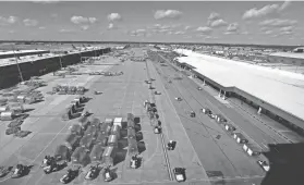  ?? MIKE BROWN/THE COMMERCIAL APPEAL ?? The ramp at the FedEx Hub at Memphis Internatio­nal Airport bustles with activity during the day sort of packages.