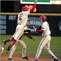  ?? NWA Democrat-Gazette/J.T. WAMPLER ?? Arkansas junior Hunter Wilson celebrates with Heston Kjerstad (right) after Kjerstad’s game-winning RBI single against Auburn on Sunday at Baum Stadium in Fayettevil­le. The Razorbacks swept the three-game series against the Tigers.