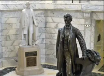  ?? TIMOTHY D. EASLEY — THE ASSOCIATED PRESS ?? In this Wednesday file photo, a statue of Jefferson Davis, left, looks towards a statue of Abraham Lincoln in the Rotunda of the Kentucky State Capitol in Frankfort, Ky.